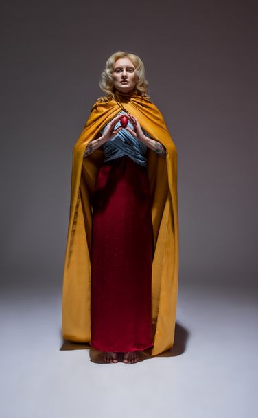 Girl in medieval  dress and easter egg - 写真・画像