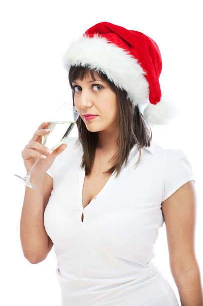 Young woman with santa hat drinking champagne - 写真・画像