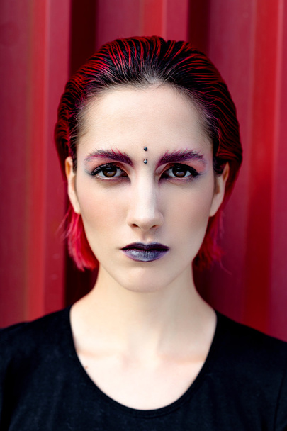 Attractive young woman with colorful makeup - 写真・画像