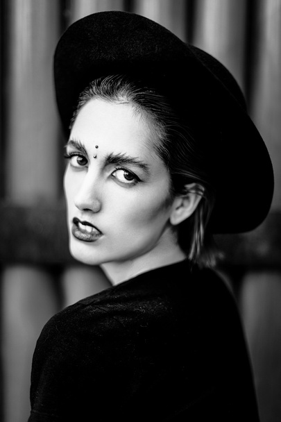 Attractive woman in black rounded hat - Foto, afbeelding