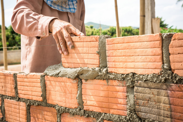 builder laying bricks in site. - Photo, Image