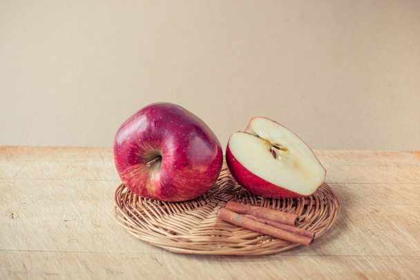 apple, cinnamon sticks and apple cider vinegar on a wooden board - Valokuva, kuva
