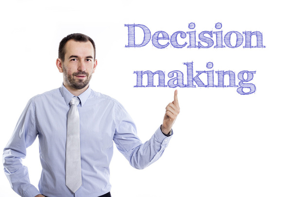 Decision making - Young businessman with small beard pointing up in blue shirt - Photo, Image