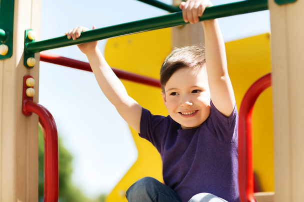 happy little boy climbing on children playground - Zdjęcie, obraz