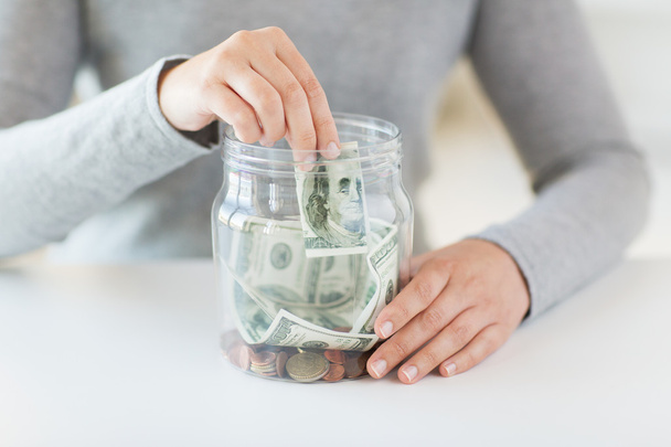close up of woman hands and dollar money in jar - Fotoğraf, Görsel