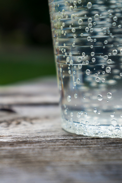 water with lime in a plastic cup - Photo, Image