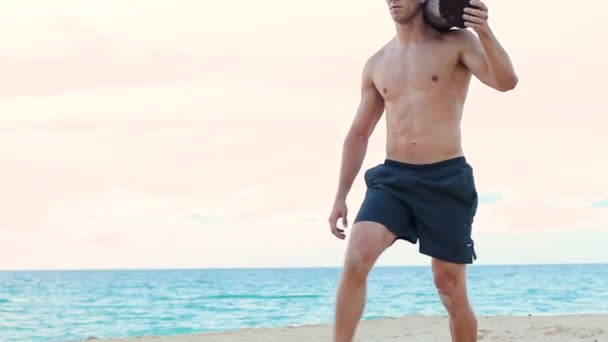 Fit Young Man Exercising on Beach. Crossfit Work Out. Healthy Active Lifestyle. - Materiaali, video