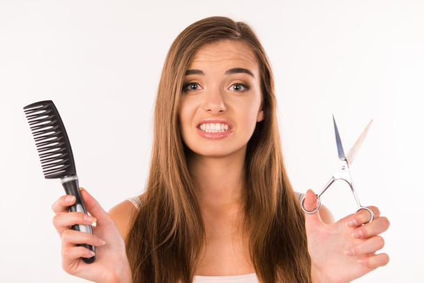 girl chooses scissors or comb,  long hair or short - Foto, Bild