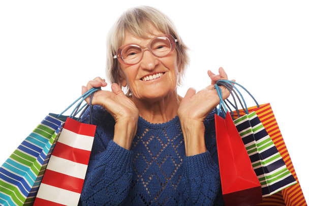 Happy senior woman with shopping bags - Foto, afbeelding