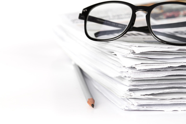 reading eyeglasses with stacking of newspaper background , busin - Photo, Image