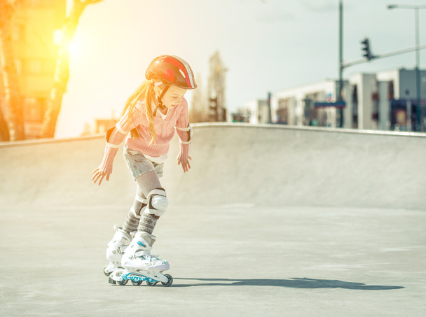Little pretty girl on roller skates  - Zdjęcie, obraz
