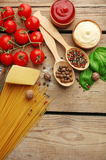 Pasta spaghetti with tomatoes, cheese and basil on rustic wooden  background - Valokuva, kuva