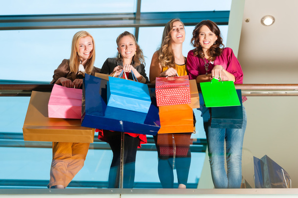 Four women friends shopping in a mall - Photo, Image