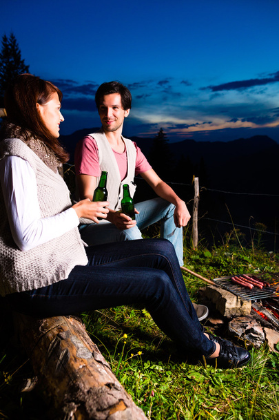 Alps - Couple at campfire in mountains - Photo, Image
