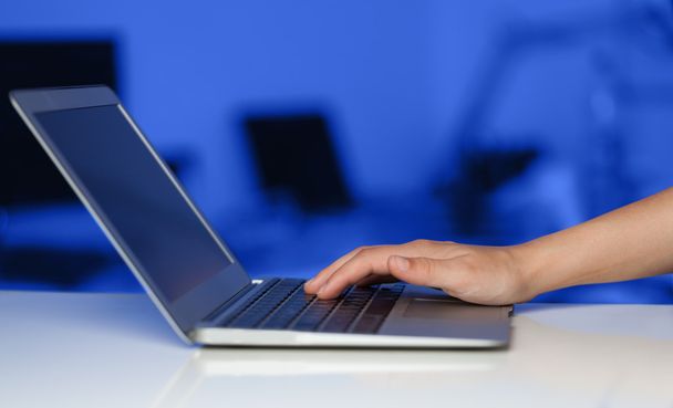 Businessman pressing modern laptop computer on colorful backgrou - Photo, Image