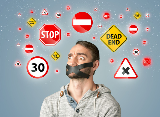 Young man with glued mouth and traffic signals - Fotoğraf, Görsel