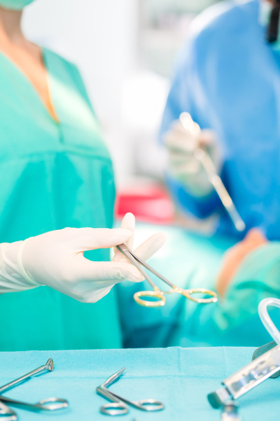 Surgeons operating patient in operating room - Photo, Image