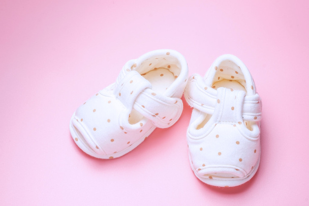 cute baby shoes for kids on pink background. - Фото, зображення
