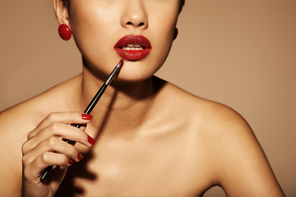 woman applying red lipstick - Photo, Image
