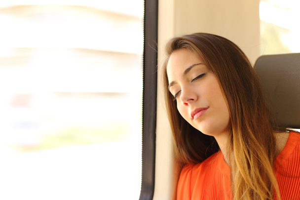Woman sleeping inside a train during a travel - Foto, Imagen