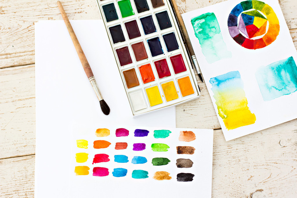 Workplace artist - paper, paint, brushes, color wheel. Mock up. - Fotó, kép