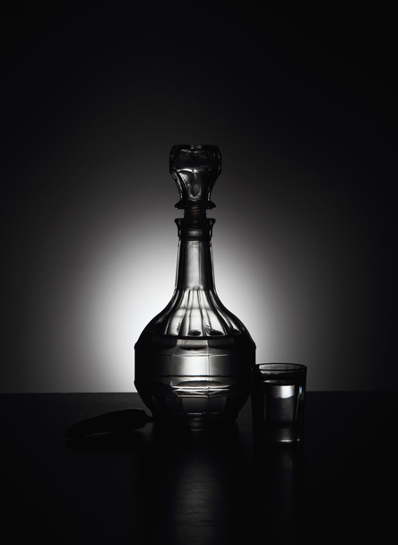 Decanter with vodka on a blue background - Фото, изображение
