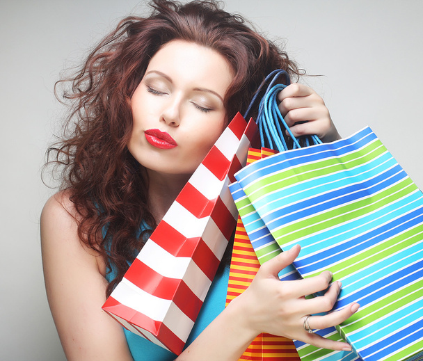 beautiful young woman with colored shopping bags - Foto, imagen