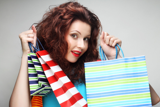beautiful young woman with colored shopping bags - Fotó, kép
