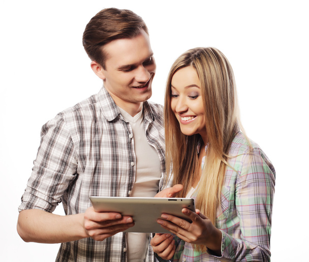happy young couple holding tablet pc computer  - Фото, изображение
