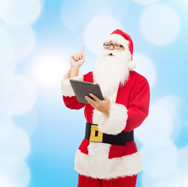 man in costume of santa claus with tablet pc - Foto, immagini