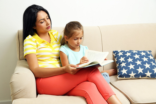 little girl reading book with mother - Photo, Image