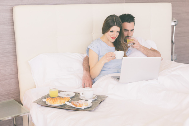 Couple having breakfast on the bed  - Zdjęcie, obraz