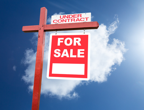 En venta signo para el hogar en frente del cielo azul
 - Foto, imagen