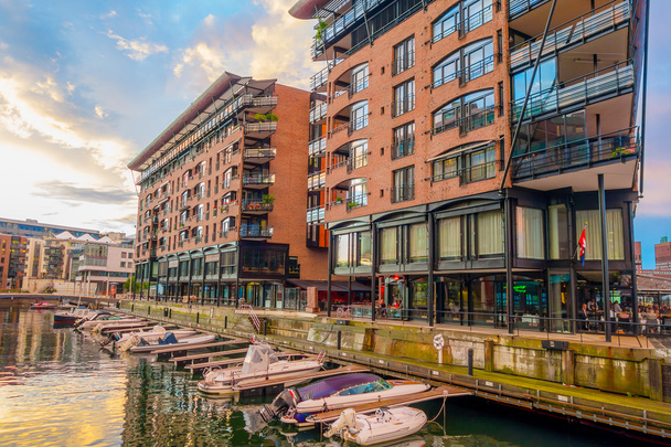 OSLO, NORWAY - 8 JULY, 2015: Charming modern rustic architectural apartment and office buildings waterfront at Aker Brygge during sunset hour - Foto, afbeelding