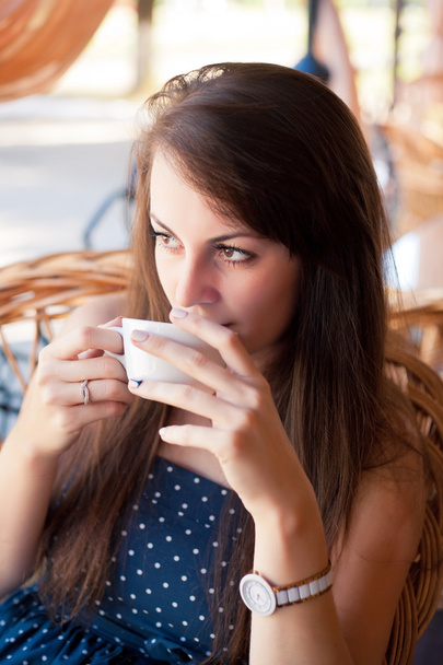 Close-up portrait of the beautiful woman with a coffee - Photo, Image