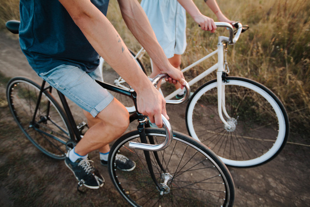 young couple on vintage bikes riding - Фото, зображення