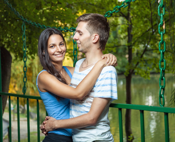 Happy couple embracing in the park - 写真・画像
