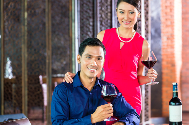 Asian couple with glass of red wine - Photo, Image