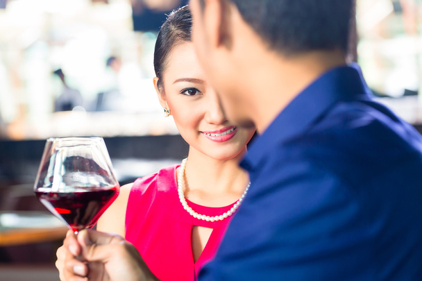 Asian couple with wine in Restaurant - 写真・画像