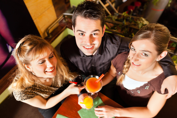 people drinking cocktails in bar or restaurant - Photo, Image