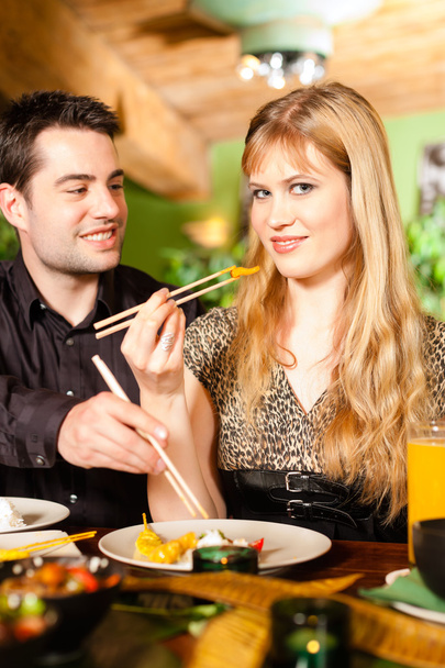 Young people eating in Thai restaurant - Photo, image