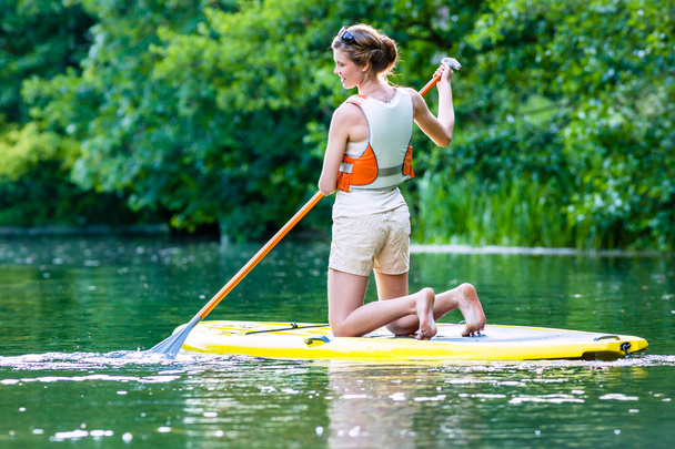 Woman with stand up paddle board sup on river - Photo, Image