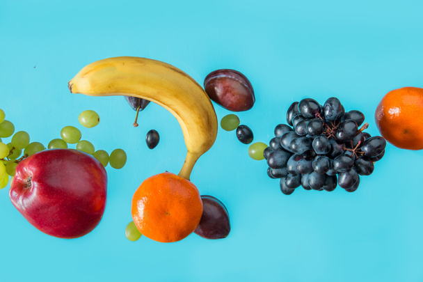 Fresh fruits on a blue background. - Фото, изображение