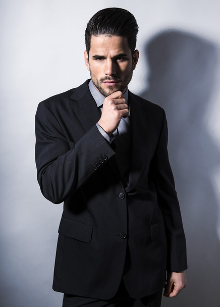 handsome young man in suit on grey background - Fotografie, Obrázek