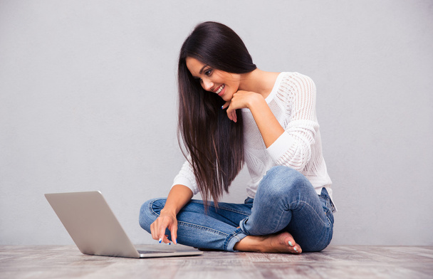 Woman sitting on the floor and using laptop - Photo, image