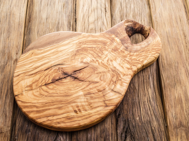 Chopping board on the wooden table. - Fotó, kép