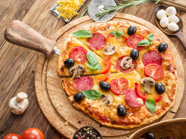 Pizza with mushrooms, salami and tomatoes. - Фото, зображення