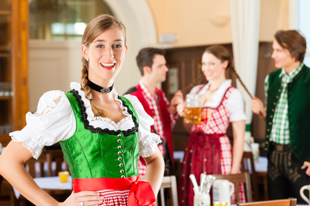 people in traditional Bavarian Tracht in restaurant or pub - Fotoğraf, Görsel