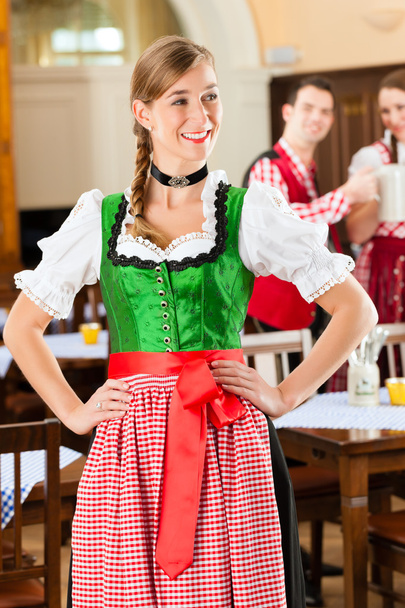 people in traditional Bavarian Tracht in restaurant or pub - 写真・画像