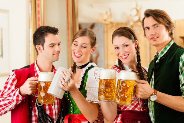 people in traditional Bavarian Tracht in restaurant or pub - Photo, Image